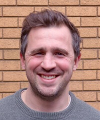 A head and shoulder portrait of Tom Hocking