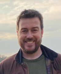 A head and shoulder portrait of Tom Kelly